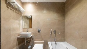 A bathroom with a sink, toilet, and bathtub. - HOTEL GOLDEN TULIPZ (Mumbai)