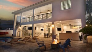 A modern two-story house with a large open-plan living area, a pool, and a bar.