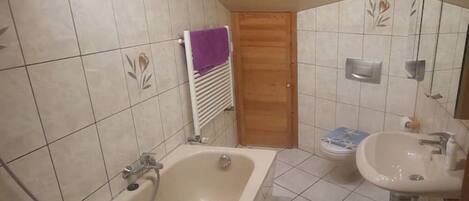 A bathroom with a bathtub, a sink, and a shower.