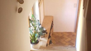 A wooden staircase leading to a room with a herringbone floor pattern. - Sigrid's vacation apartment Bad Tölz (Bad Tölz)