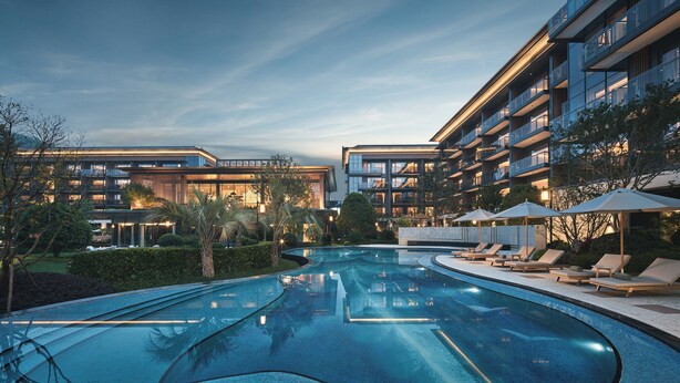 A modern hotel with a swimming pool, multiple balconies, and lounge areas. - Hotel Indigo Hangzhou Tianmushan by IHG (Hangzhou)