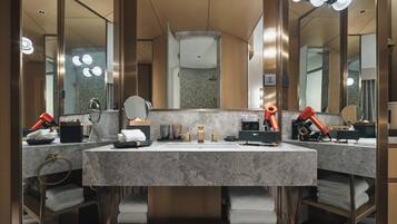 A modern bathroom with two sinks, large mirrors, and hair dryers.