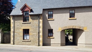 A stone building with a gabled roof, multiple windows, and a stone archway. - 10 minutes from the local beach great surfing beach
License Nr.HI-00282-F (Thurso)