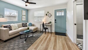 A compact living space with a sofa, coffee table, and a dining area. - Quiet Studio Guesthouse in Jax - Near Downtown (Jacksonville)