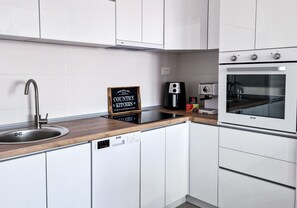 Réfrigérateur, un four, surface de cuisson, lave-vaisselle