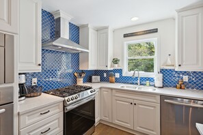 Fridge, dishwasher, coffee/tea maker, cookware/dishes/utensils