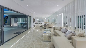 A modern interior with a sofa, coffee table, and a glass partition. - Luxury Villa Nimai Luce Istria with Heated Pool (Kastelir)