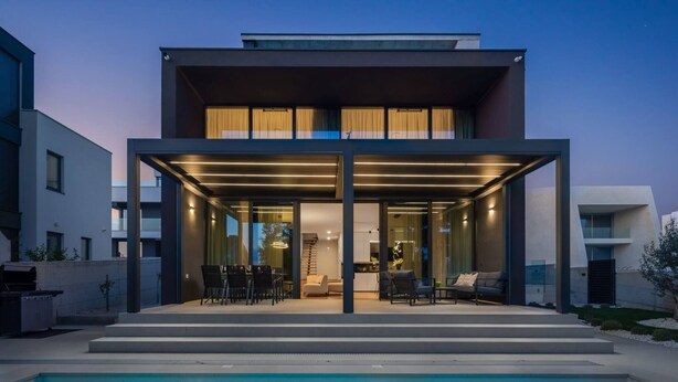 A modern two-story house with a covered outdoor area, a pool, and a staircase leading to the upper floor. - Luxury Villa Idria Zadar with Heated Pool (Petrčane)