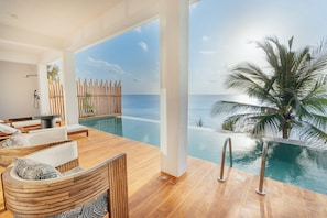 A modern infinity pool with a wooden deck, lounge chairs, and a view of the ocean. - Kwanza Resort By SUNRISE (Kizimkazi)