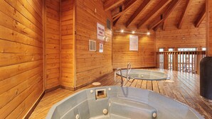 A wooden cabin with two hot tubs, wooden walls, and a wooden deck. - Walk across the street to the Snowflake Chair! Beautiful 4BR Condo with great am (Breckenridge)