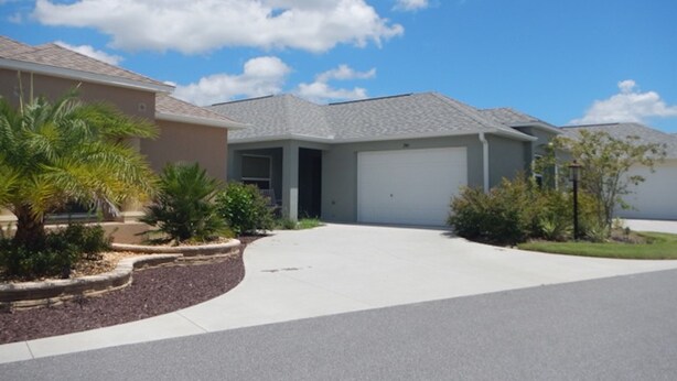 A residential house with a garage, a driveway, and a well-maintained lawn. - 741 Adrienne Way (Wildwood)