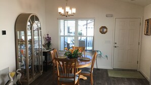 A dining area with a wooden table, chairs, and a chandelier. - 2454 Lewis Ln (Wildwood)