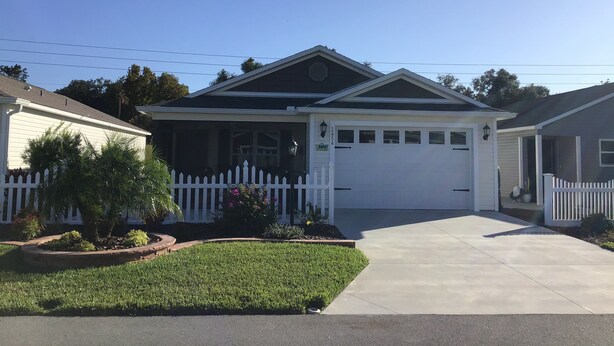 A single-story house with a front porch, a garage, and a well-maintained lawn. - 2454 Lewis Ln (Wildwood)