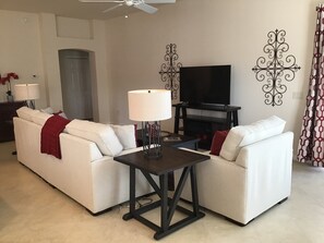 Villa, Multiple Beds, Patio, Garden View | Living area | TV, fireplace - 1111 Peninsula Street (The Villages)