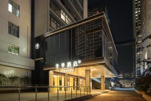 A modern hotel entrance with a glass facade, a visible sign with Chinese characters, and a well-lit exterior. - Ji Hotel Shenzhen Huaqiang North Electronic Buildi (Shenzhen)