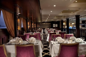 A restaurant with tables set for dining, featuring a patterned floor and a view of the outdoors. - Steigenberger Minerva Cruise 4&7 Nights From Luxor (Luxor)