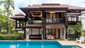 A two-story house with a swimming pool, outdoor seating, and a covered patio. - Sclass Pool Villa, City area and airport (.)