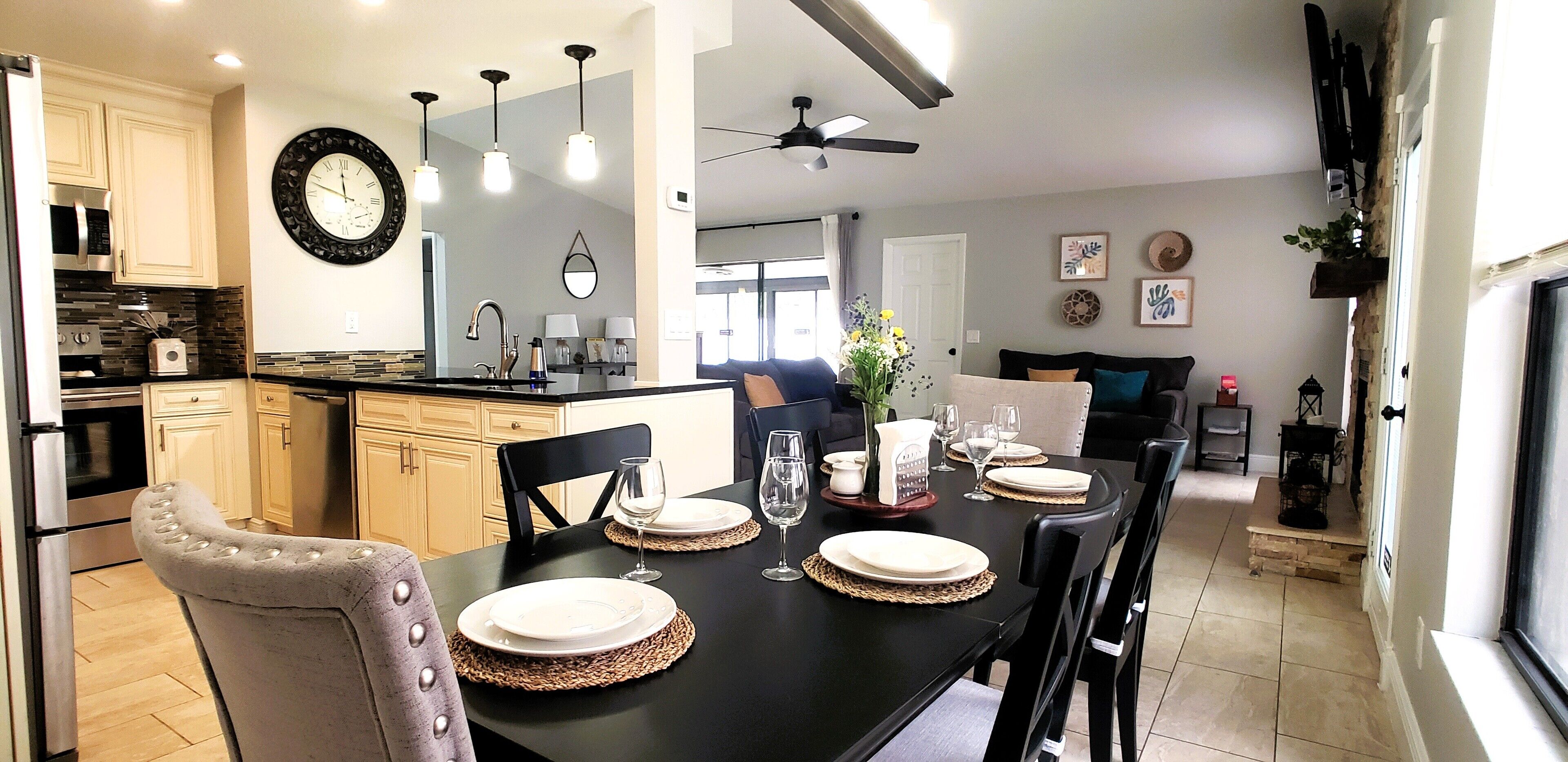 A modern kitchen with a dining area set for a meal.