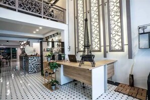 A modern office space with a wooden desk, shelves, and decorative items. - Sclass Townhome, 5 min from Night Market old city (.)