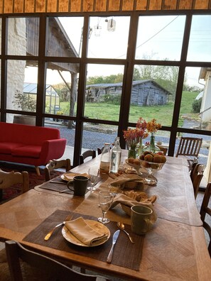 Enjoy meals in this inviting dining area with a long table and views of the outdoors.