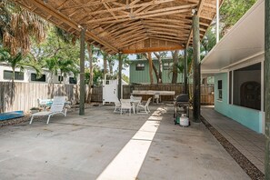 Enjoy al fresco dining and socializing in this outdoor patio area with a barbecue grill and comfortable seating.