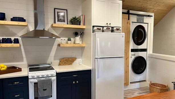 A kitchen with a stove, oven, refrigerator, and a washing machine.