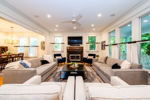 Relax in this stylish living room with a fireplace, flat-screen TV, and comfortable seating for two.