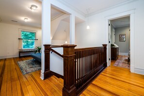 A staircase with wooden railings leading to an upper floor. - 2027 OPEN! Union Pier Home With Pool and Hot Tub! Close To Private Beach! (Union Pier)