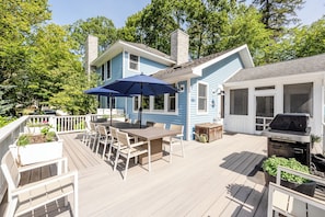 A deck with a table and chairs, a barbecue grill, and a covered patio area. - 2027 OPEN! Union Pier Home With Pool and Hot Tub! Close To Private Beach! (Union Pier)