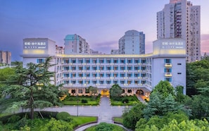 A hotel with a central courtyard, multiple floors, and a modern architectural design.