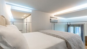 A modern bedroom with a large bed, built-in wardrobe, and a glass partition. - B&B Civico 33 - Parthenope Qdpl (Napoli)