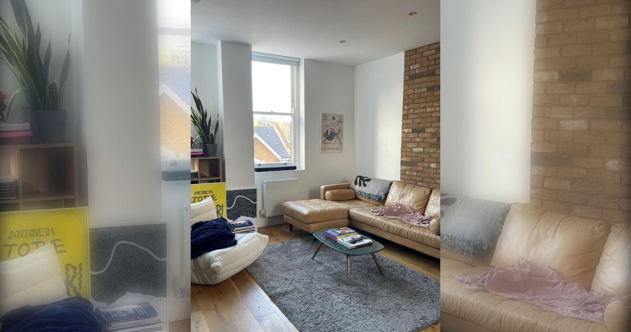 A modern living room with a leather sofa, a coffee table, and a brick accent wall.