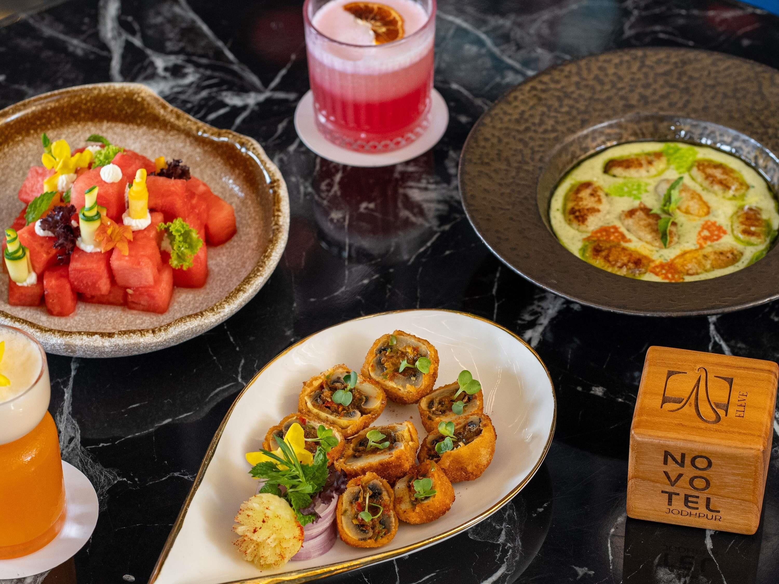 A marble table with various dishes, a drink, and a wooden block with text.