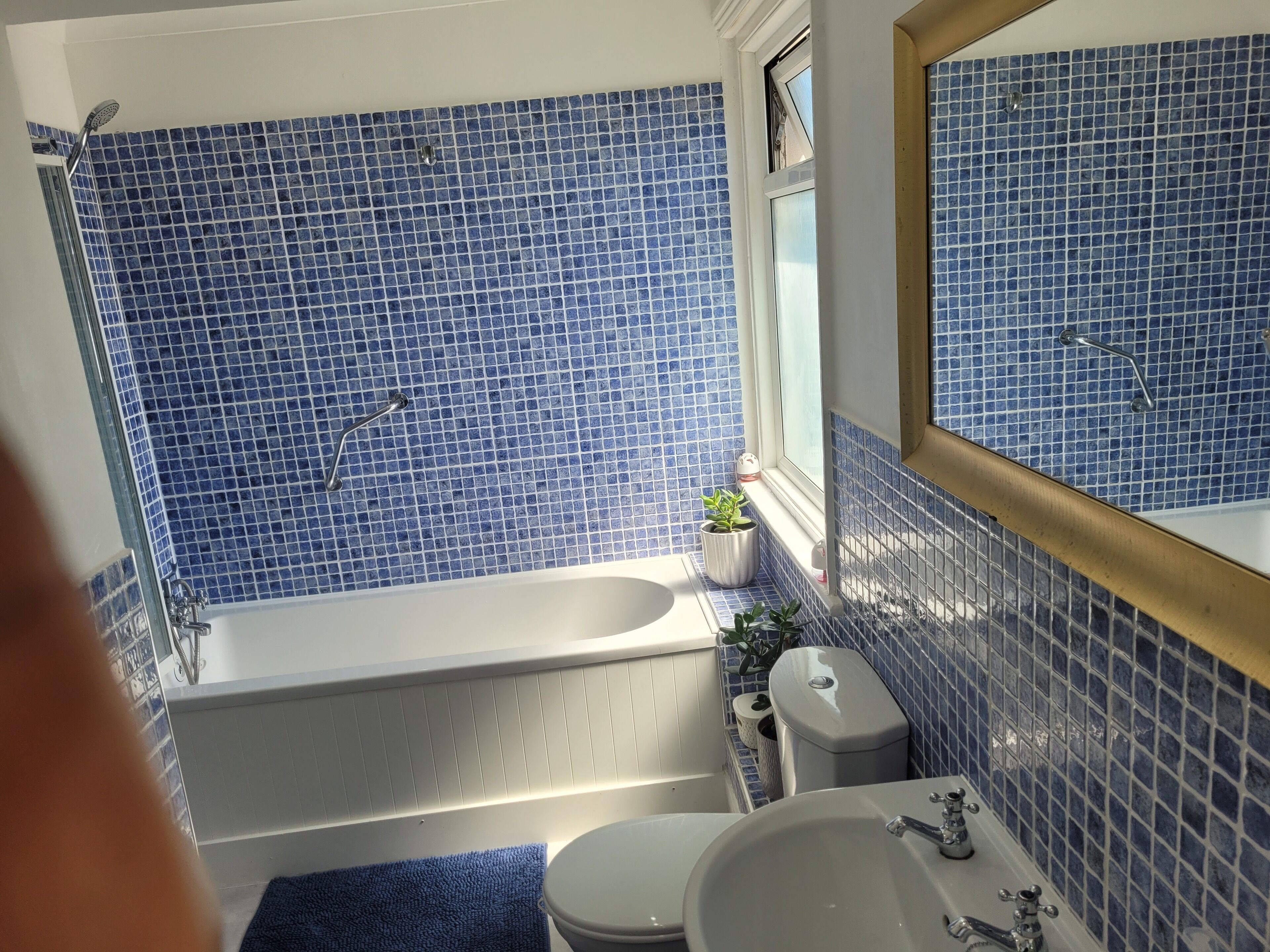 A bathroom with a bathtub, a sink, and a toilet.