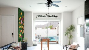 A modern living room with a sofa, armchairs, a coffee table, and a decorative wall. - Modern Wanderlust - Pool - Spa -Views - 3B2B259320 (La Quinta)