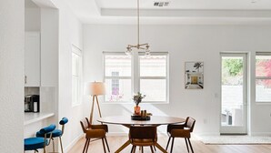 A dining area with a round table, four chairs, and a chandelier. - Casita Azul - Resort Amenities, Tennis 2BR260196 (La Quinta)