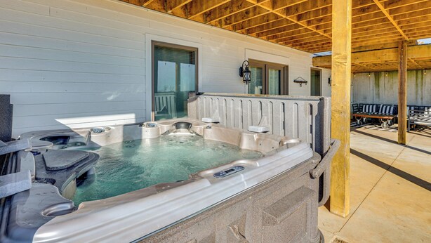 A hot tub area with a wooden ceiling and a stone wall. - Rustic Missouri Vacation Rental w/ Hill Views! (Greenfield)