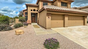 A two-story house with a tiled roof, a garage, and a gravel driveway. - Private Pool & Yard: Central Cave Creek Retreat! (Cave Creek)