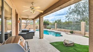 An outdoor patio with a pool, a grill, and a covered seating area. - Private Pool & Yard: Central Cave Creek Retreat! (Cave Creek)