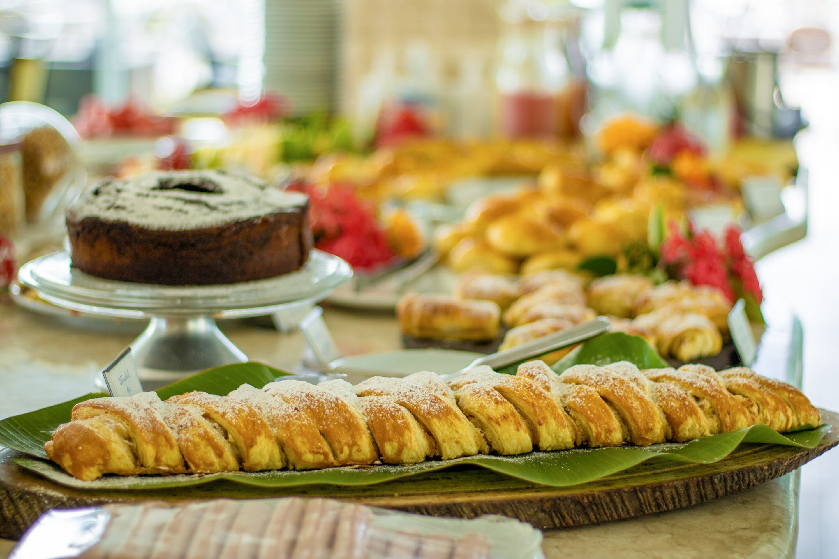 A buffet with various pastries and desserts on display.