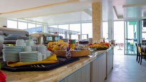 A buffet area with various food items and utensils. - Pousada Jirituba (Barra de Santo Antonio)