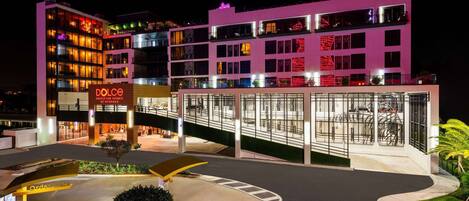 A multi-story hotel with a prominent sign reading "DOLCE HOTEL & RESORTS."