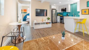 A modern kitchen with a central island, stainless steel appliances, and a bright backsplash. - Pet-Friendly OB Bungalow w/ Patio, Grill & Walk to Beach (San Diego)