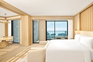 Relax in comfort with a large bed and seating area, offering a view of the outdoors.