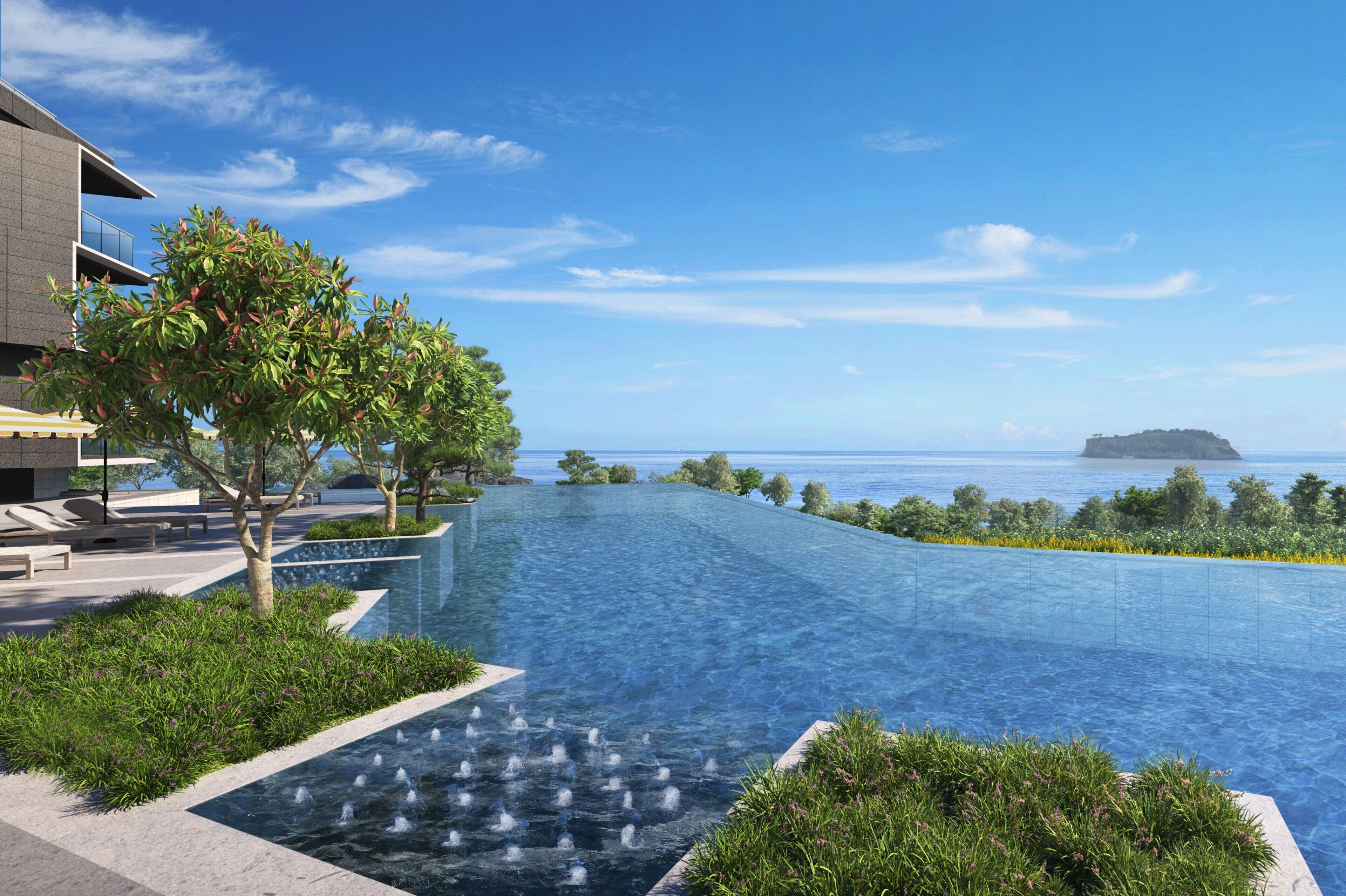 A modern hotel with an infinity pool, lush greenery, and a view of the sea.