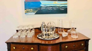 A wooden dresser with a painting of a ship on the wall above it. - Salt Box II, One Block to the Beach (Cape Charles)