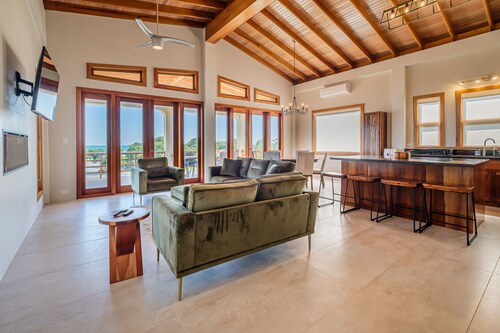 Tropical retreat with a pool, dock, bikes, canoes, balconies, and 360 views