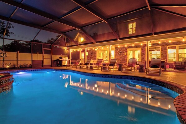 A swimming pool with lounge chairs and a covered patio area. - Lux Vacay Near AMI & IMG: PCKL Ball, Pool, Put Put (Bradenton)