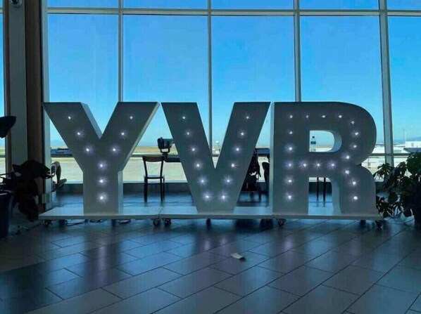 Located near Vancouver International Airport, this property features a spacious indoor area with a prominent illuminated sign.