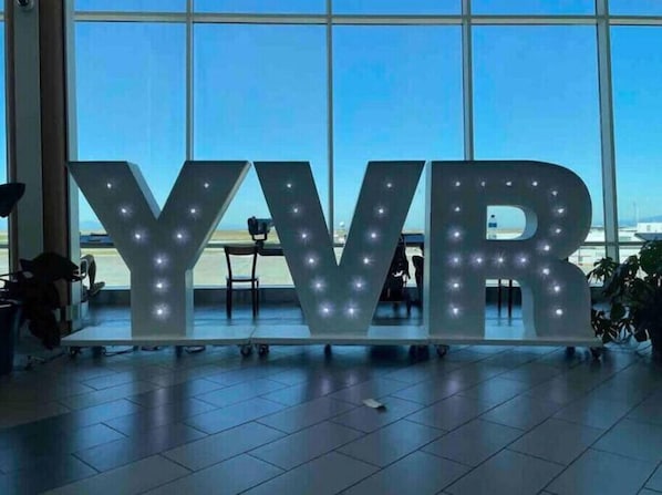 Located near Vancouver International Airport, this property features a spacious indoor area with a prominent illuminated sign.